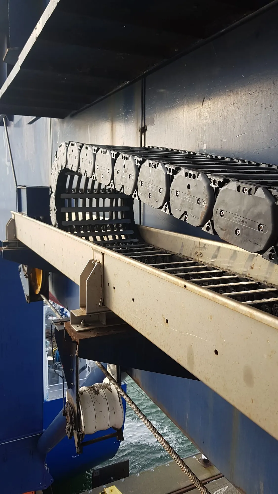 Zware kabelrups in de geleidegoot van een containerkraan