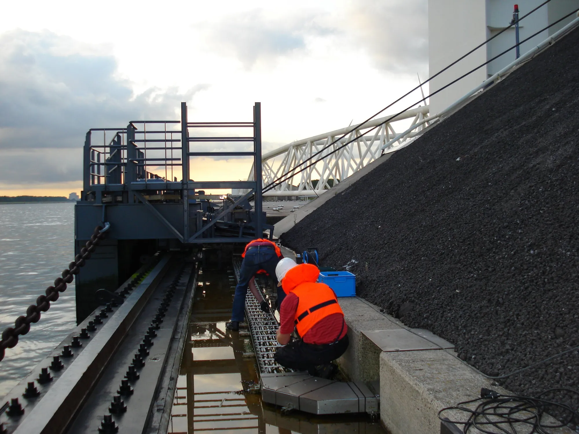 Technicians working on the stainless steel cable carrier at the Maeslantkering