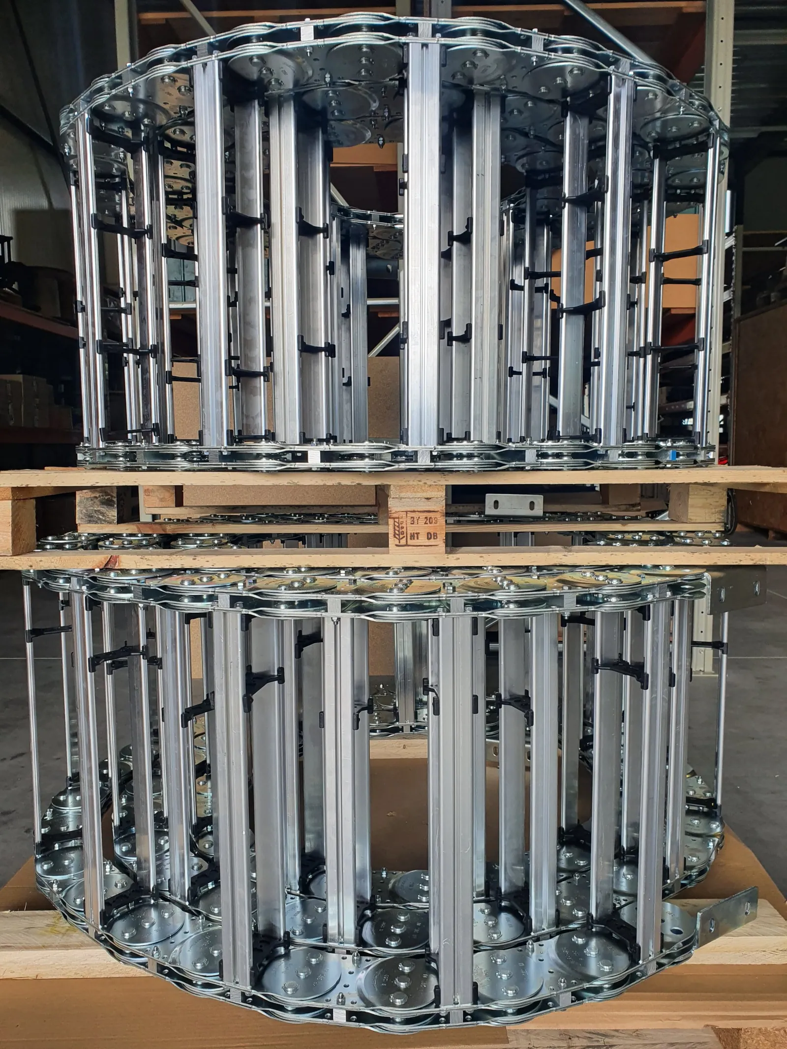 Two rolls of steel S1250 cable carrier with a double chain band on a pallet