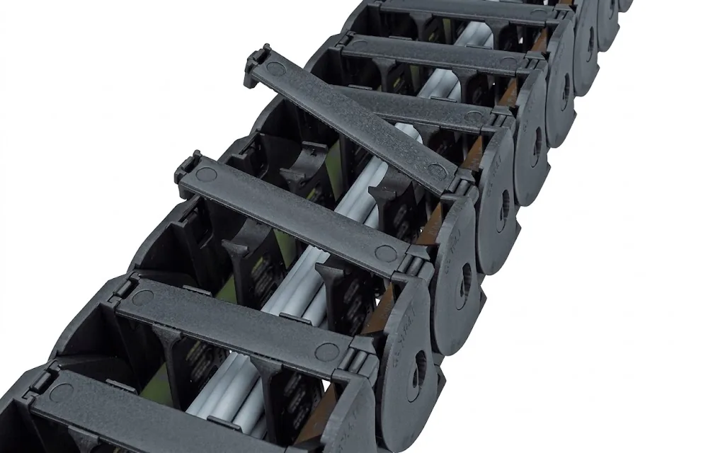 Black cable carrier with a hinged-open crossbar, partly filled with cables